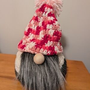 handmade yarn Xmas gnome with tall hat, wood nose, beard, and on a wood base